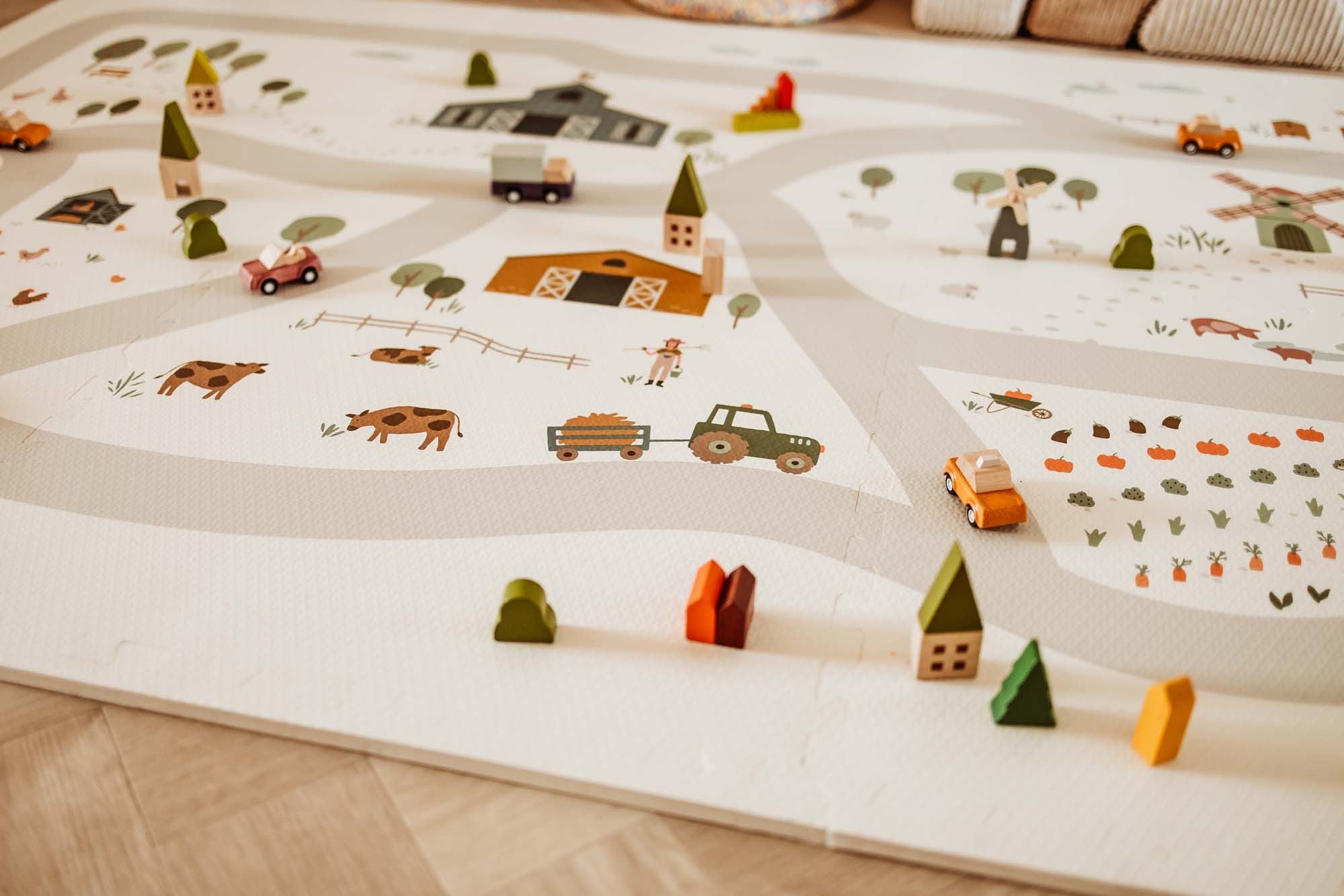 detail of EEVAA farm puzzlemat, wooden toys, lots of colors