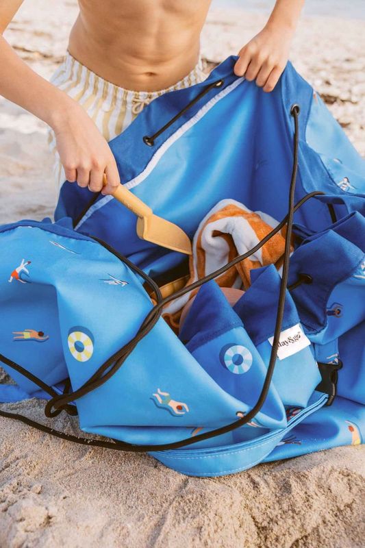 swim fun outdoor beach bag, child is putting toys in the bag