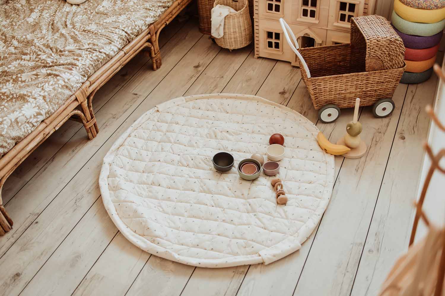 Moon organic babymat, open on floor in kidsroom next to victorian house, bed and stroller