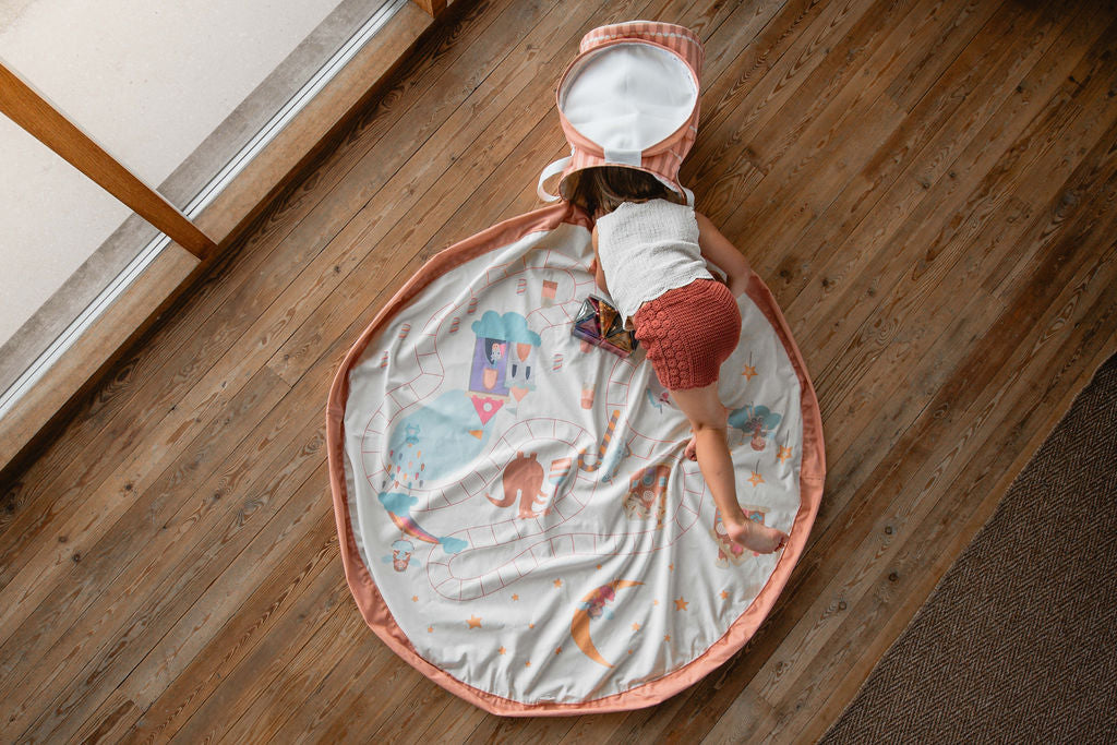 soo fairyworld, child is standing on the mat while putting its had into the basket