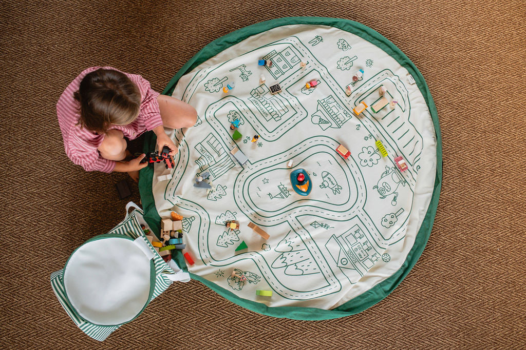 soo roadmap, open basket and open mat, lots of wooden toys, child is playing with the toys