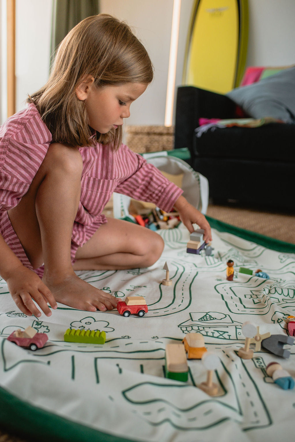soo roadmap, child is playing with wooden toys on mat in living room