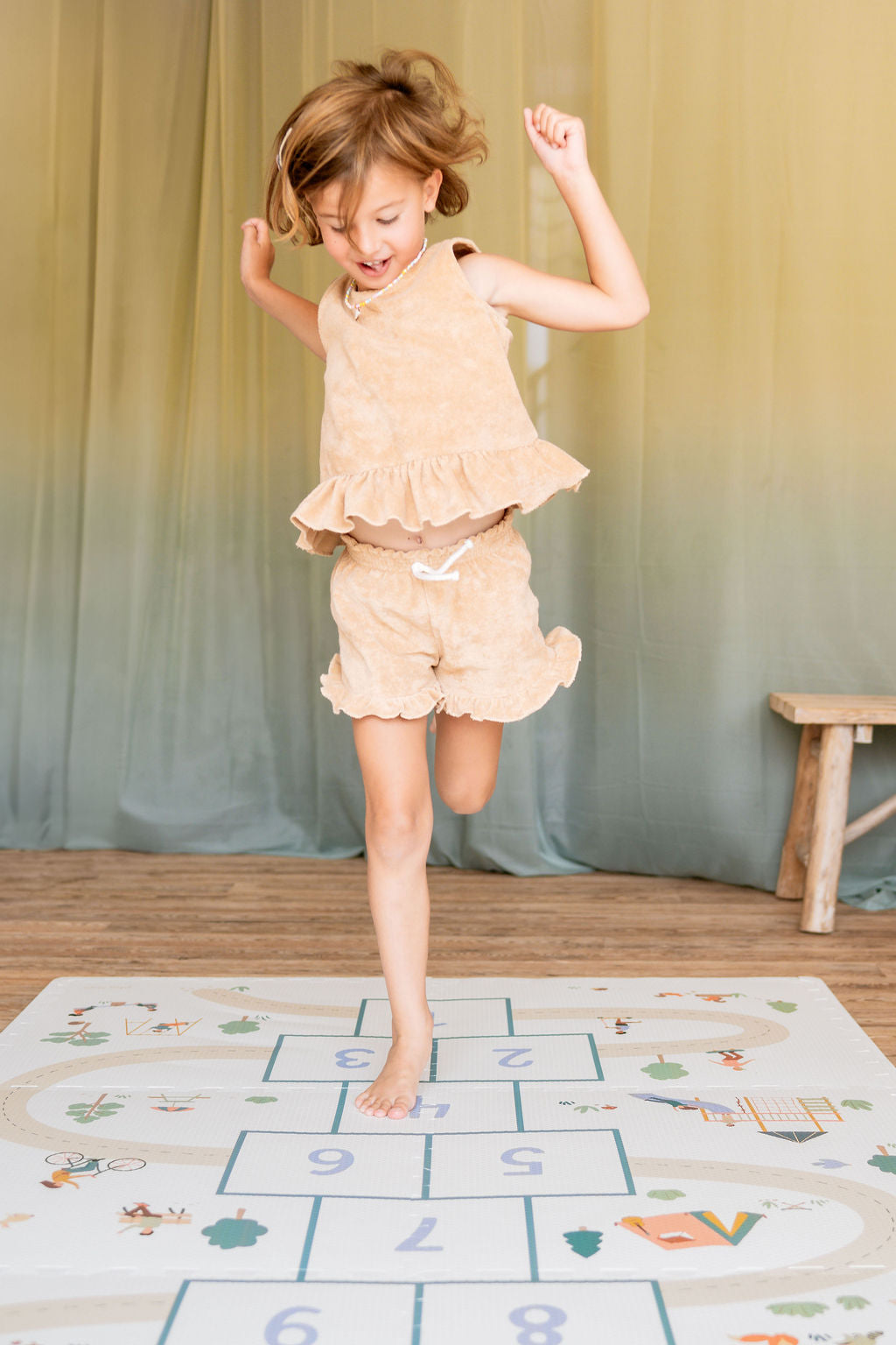 tiloo hopscotch, child is jumping on the mat, having fun