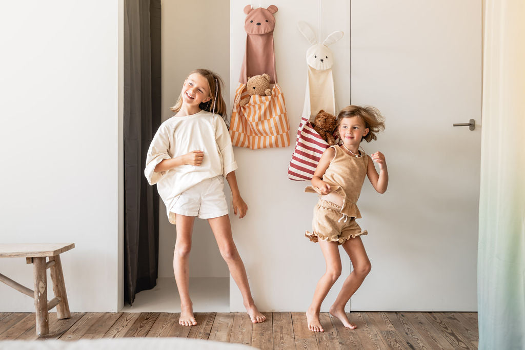 toto bear and toto bunny, hanging on wall, children have put cuddles in the bags