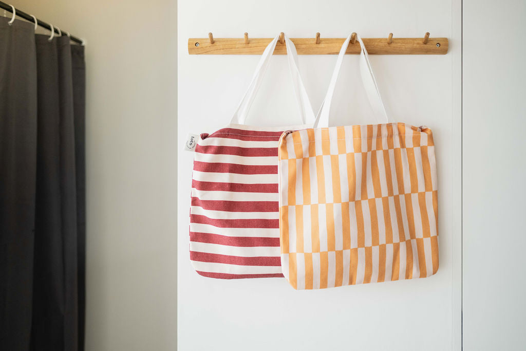 toto bear and toto bunny, hanging on coat rack on wall, transformed into bags