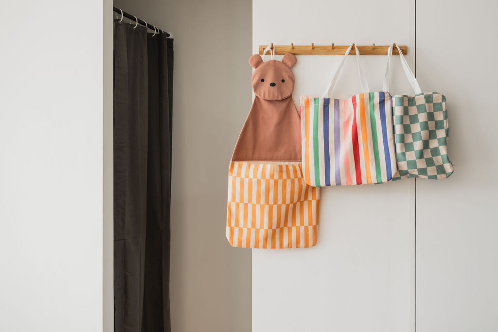 toto bear, hanging on coat rack on wall, toto unicorn and toto dino transformed into a bag