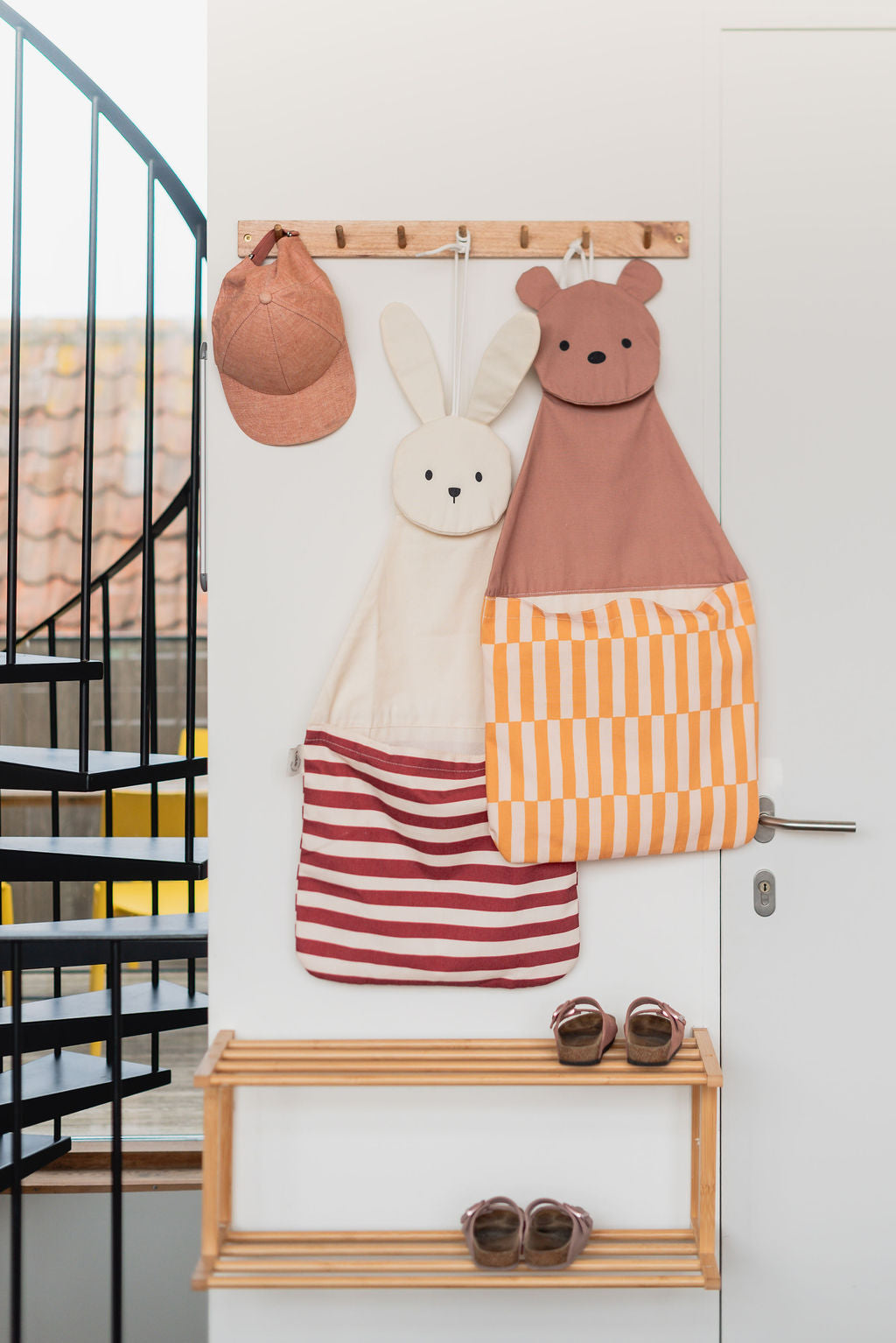 toto bear and toto bear, hanging on a coat rack on wall, cap and shoes