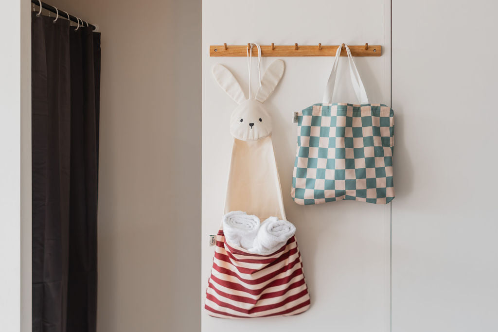 toto bunny, hanging on coat rack, filled with towels, toto dino transformed into a bag