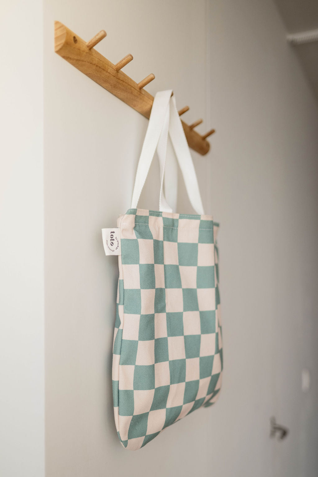 toto dino, hanging on a coat rack, transformed into a bag