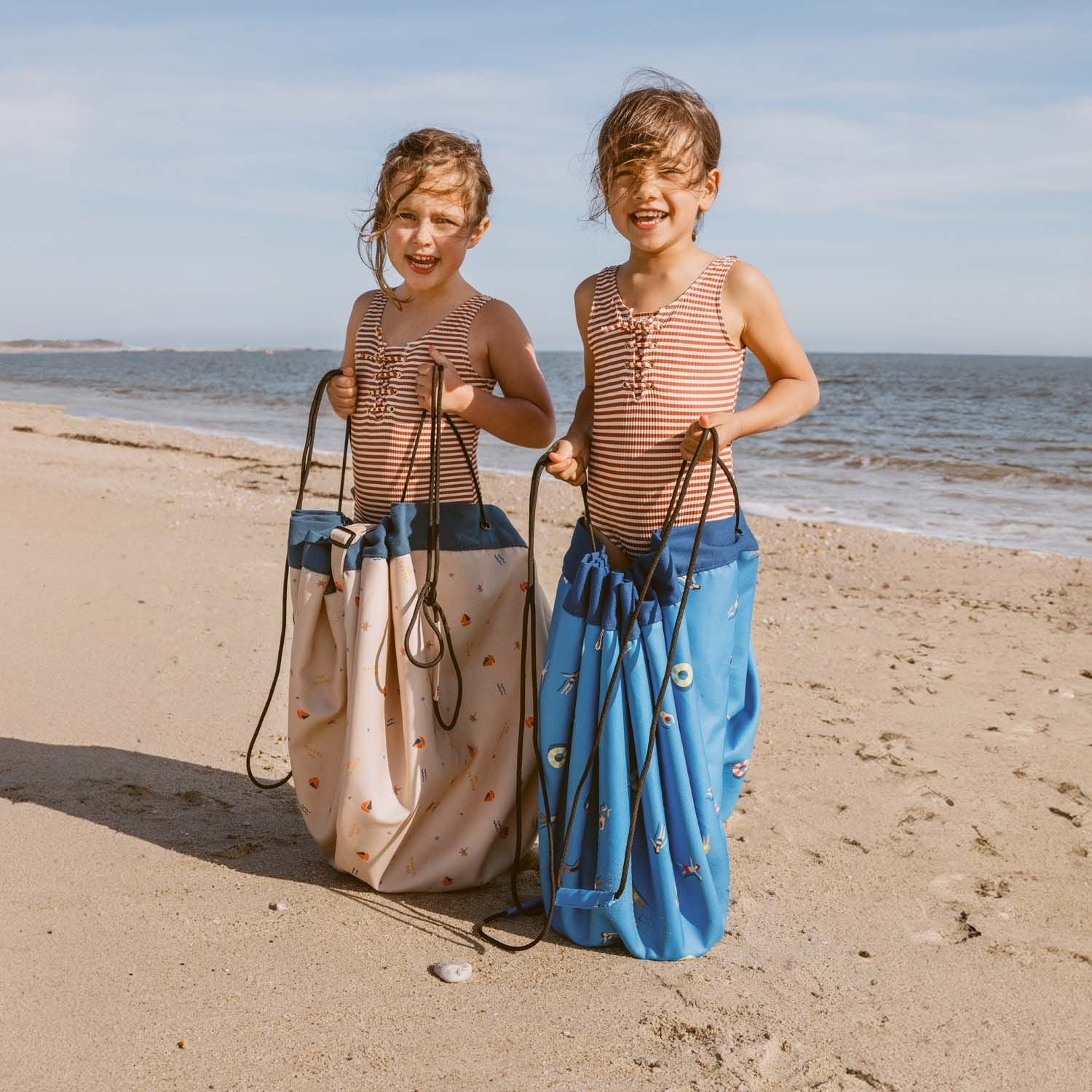 outdoor beach bags swim fun and magical days, children in bading suits are staning in the bags