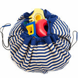 Beach outdoor storage bag, blue and white striped drawstring bag filled with colorful toys 