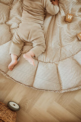 bloom stripes blue babymat, open on floor, baby is lying on the mat, wooden blocks