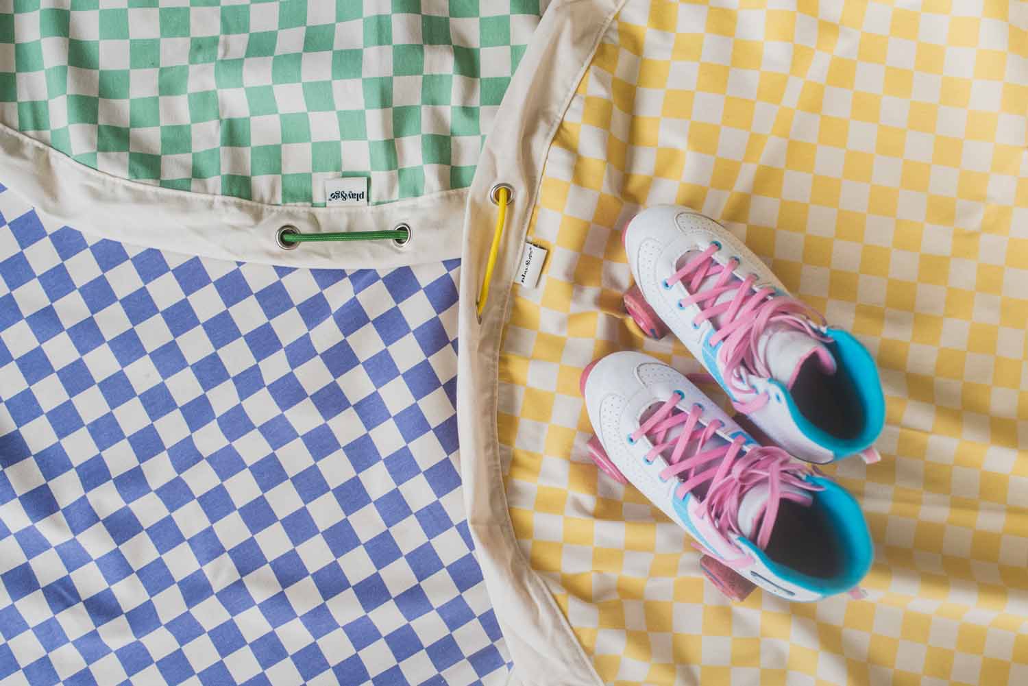 vichy toy storage bags, all colors, open bags, roller skates on top of the yellow one