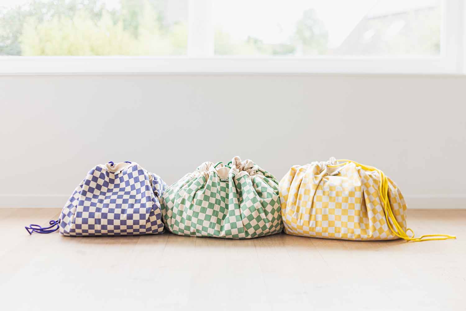 vichy toy storage bags, all colors, closed bags standing next to each other on the floor
