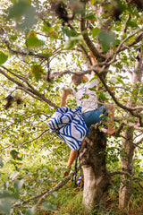 Pirate outdoor storage bag, child is carrying the bag on its shoulder while climbing in a tree