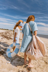 magical days outdoor beach bag, child is carrying the bag with the shoulderstrap, other child is holding a swimming band