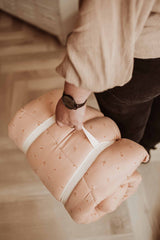 Fleuri organic babymat, person is carrying the closed mat