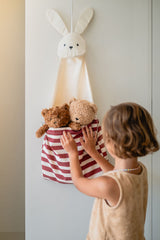 toto bunny, hanging on wall, child has put its 2 cuddle bears into the bag