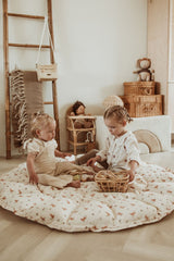 bloom rabbit babymat, open on floor in kidsroom, children are sitting on the mat and playing with wooden toys