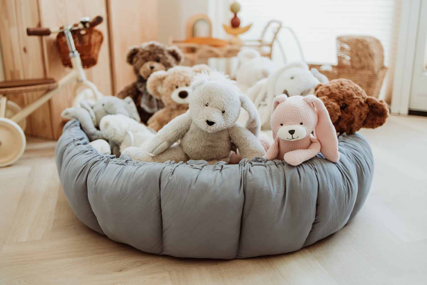 Bloom dusty blue organic babymat, raised edges, filled with cuddles, tricycle in kidsroom