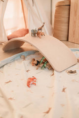 close picture of toystorage bag, jungle print, wooden brigde over mat, lots of animal toys