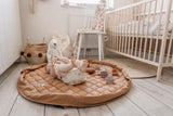Tawny Brown soft padded baby play mat, baby lying on mat in babys room, lots of toys