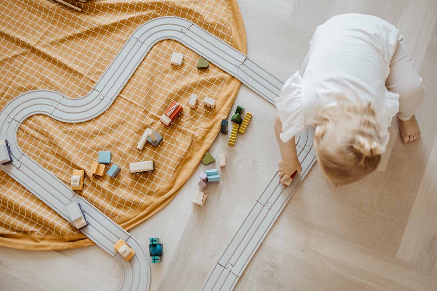 open organic grid mustard storage bag, child playing with wooden cars on road