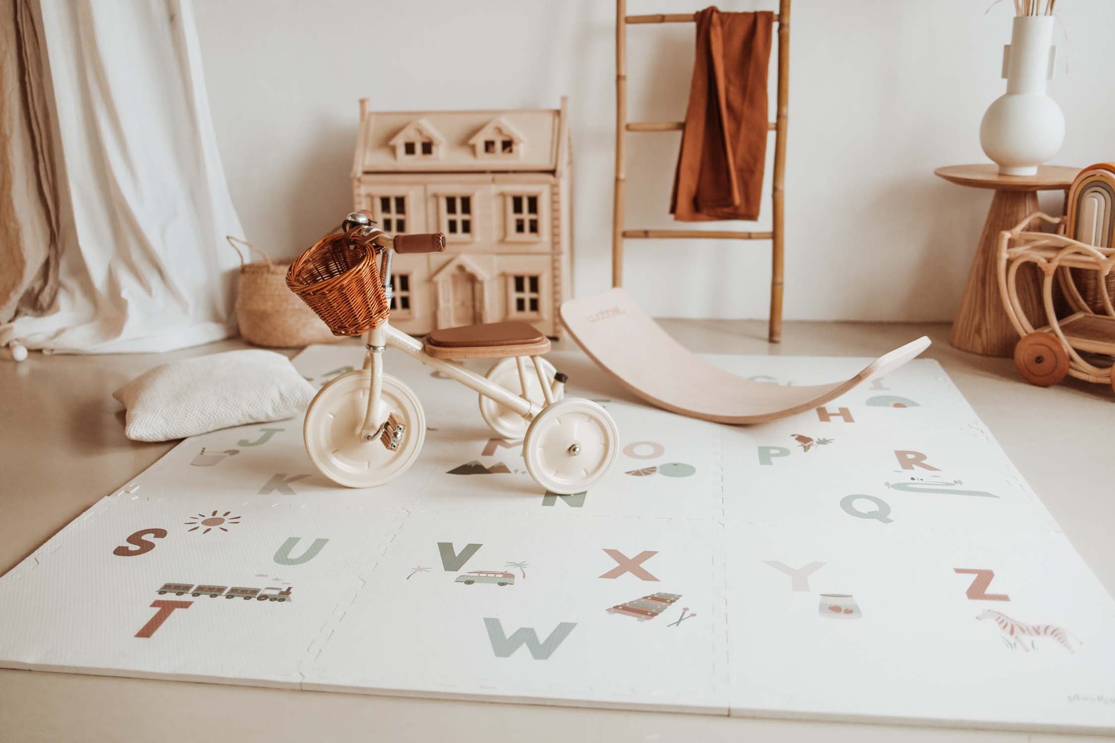 alphabet puzzlemat, tricycle and wooden slide on the mat, victorian play house in kidsroom